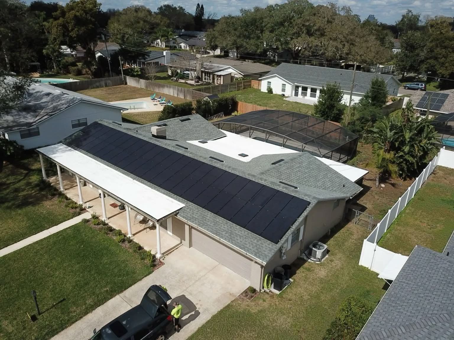 Aerial view of a full rear-roof solar array on install day